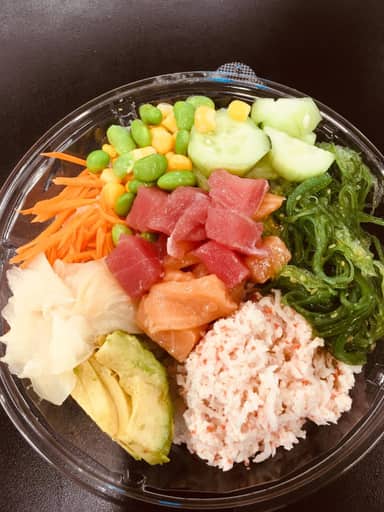 A poke bowl with tuna, salmon, crab, edamame and cucumber.