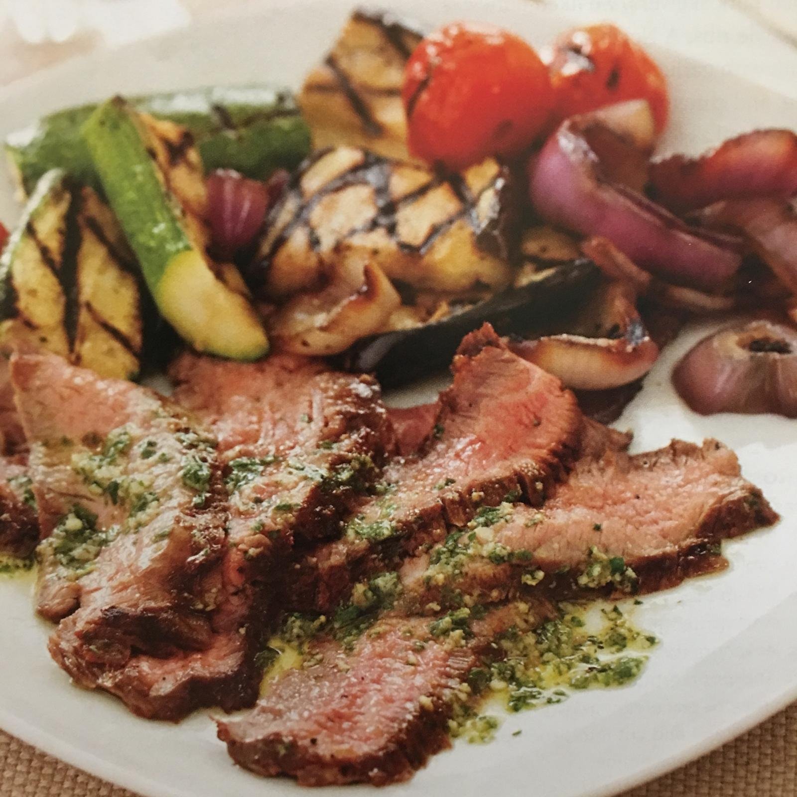 Sliced steak with grilled zucchini and onions.